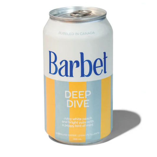 A front-facing view of a Barbet Deep Dive can, showing the brand name, product name, flavor description (juicy white peach and bright yuzu with a hint of mint), and blue and orange vertical stripes.