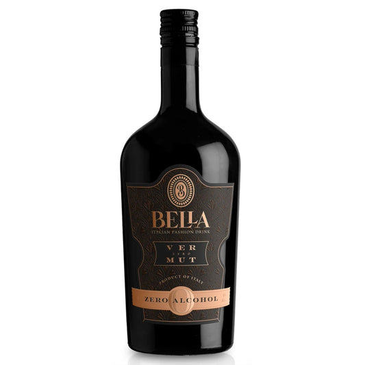 A dark, opaque bottle of Bella Vermut Zero Alcohol Italian Fashion Drink stands upright against a bright white background. The bottle has a sleek, classic shape with a black screw cap. The label is predominantly black with intricate gold and bronze detailing. At the top of the label, a gold-bordered crest with the Bella logo is visible. Below it, "BELLA" is prominently displayed in large gold lettering, with "ITALIAN FASHION DRINK" in smaller gold text directly underneath. The word "VERMUT" is spelled out.