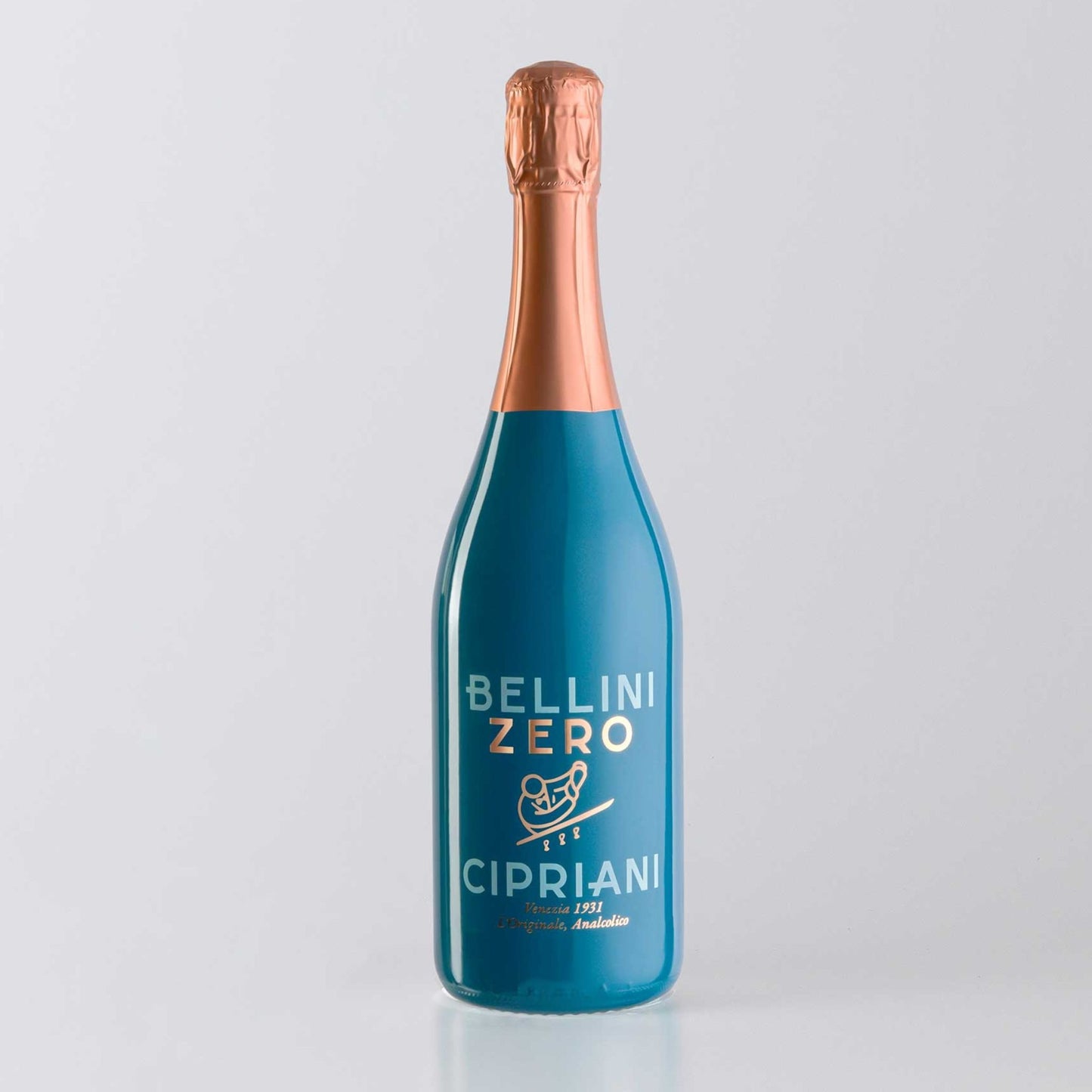 A photo of a single bottle of Bellini Zero Cipriani, a non-alcoholic sparkling peach and Prosecco mocktail. The bottle is opaque teal blue with a shiny copper foil wrapping the neck and cork. Printed directly onto the bottle in copper script and sans-serif fonts is "BELLINI ZERO" at the top, followed by a small copper illustration of a person on a scooter, and then "CIPRIANI" in larger letters. Below that, in smaller copper text, is "Venezia 1931 L'Originale, Analcolico".