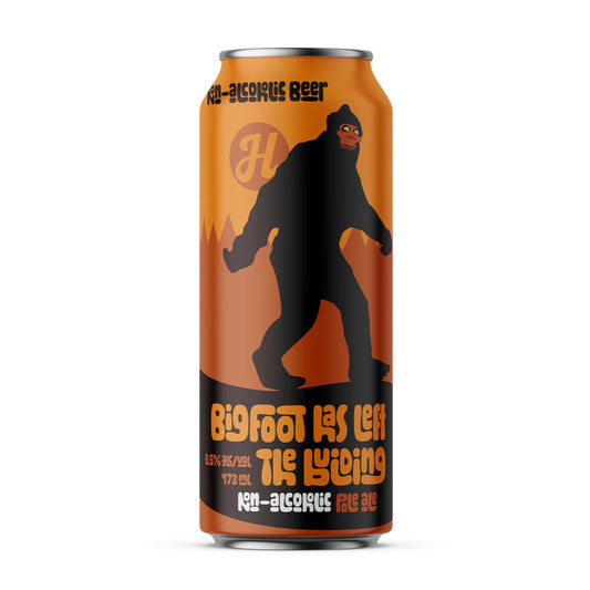 An orange beverage can featuring a large black silhouette of Bigfoot walking, with a subtle dark orange forest design in the background. At the top of the can, there's a stylized "H" logo. Text is stacked vertically on the right side of the can, reading "BigFoot has left the building" in a playful, wavy font, followed by "0.5% alc./vol." and "473 ml" on the left, and "NON-ALCOHOLIC ALE" at the bottom. The background is white.