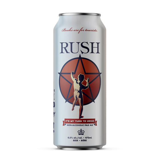 A close-up image of a silver beverage can featuring the "RUSH" logo in blue at the top. Below the logo is an orange circle with a star design, overlaying a depiction of a person with arms raised. At the bottom of the can, there's a red banner with "IT'S MY TURN TO DRIVE" and "NON-ALCOHOLIC PALE ALE" written on it. The can also displays "0.5% alc./vol. • 473ml" and "BEER • BIÈRE" along with a crown emblem. The background is a clean white, making the can stand out.