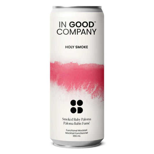A white can of In Good Company Smoked Ruby Paloma. The can has a clean, white label with a bold, reddish-pink, paint-stroke design in the middle. The label reads "IN GOOD COMPANY" at the top. Below the pink design, "Smoked Ruby Paloma" and "Paloma Rubis Fumé" are written. "Functional Mocktail," "Mocktail Fonctionnel," and "355 mL" are also visible at the bottom. The can is set against a white background.