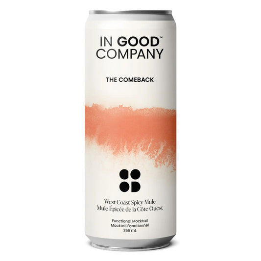 A white can of In Good Company West Coast Spicy Mule. The can has a clean label with a bold, peach-colored, paint-stroke design in the middle. The label reads "IN GOOD COMPANY" at the top. Below the design, "West Coast Spicy Mule" and "Mule Épicée de la Côte Ouest" are written. "Functional Mocktail," "Mocktail Fonctionnel," and "355 mL" are also visible at the bottom. The can is set against a white background.