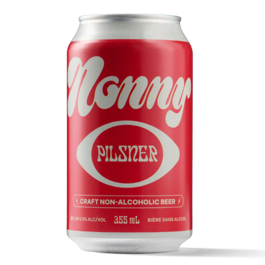 A bright red can of Nonny Pilsner non-alcoholic craft beer. The can features a stylized white script font with "Nonny" at the top and "PILSNER" inside a white oval below. The text "CRAFT NON-ALCOHOLIC BEER" is printed in white at the bottom, along with "BELOW 0.5% ALC/VOL," "355 mL," and "BIÈRE SANS ALCOOL." The background is white.