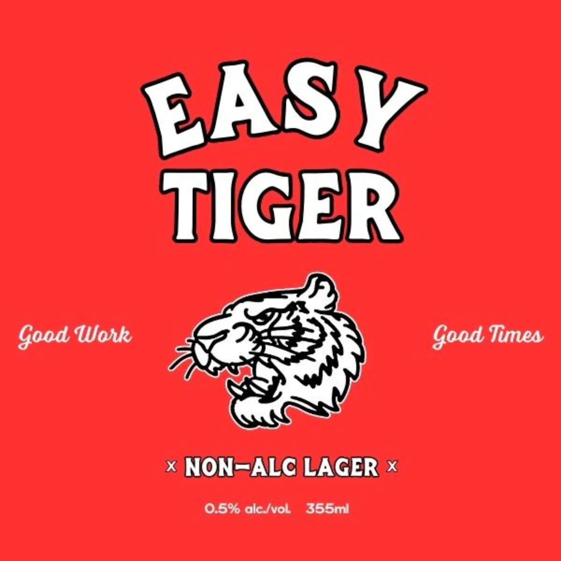A bright red label with the words "EASY TIGER" in large, stylized white letters at the top. Below this, a black and white outline drawing of a tiger's head with its mouth open. To the left of the tiger, it says "Good Work" in white script, and to the right, "Good Times" in matching script. At the bottom, a white "X" on each side of "NON-ALC LAGER" is visible, with "0.5% alc./vol. 355ml" underneath.