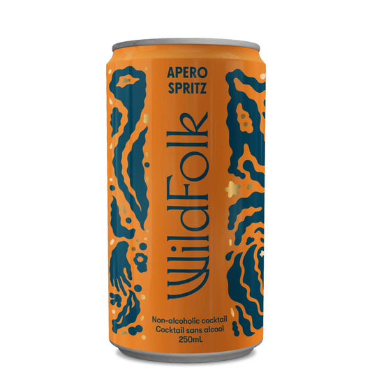 A tall, orange can of Wildfolk Apero Spritz. The can features a dark blue, stylized, abstract pattern resembling animal print or folk art. The brand name "WildFolk" is written vertically in blue on the can, with "APERO SPRITZ" and "Non-alcoholic cocktail" and "Cocktail sans alcool" written in smaller text in orange. "250mL" is at the very bottom. The can is shown on a white background.