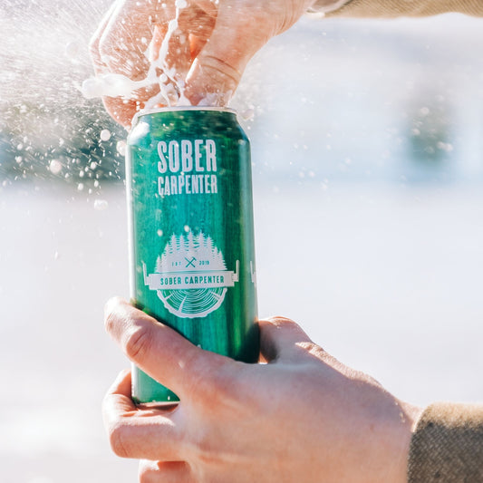 A photo of Sober Carpenter IPA being opened. Sober Carpenter IPA is available for sale at knyota.com.