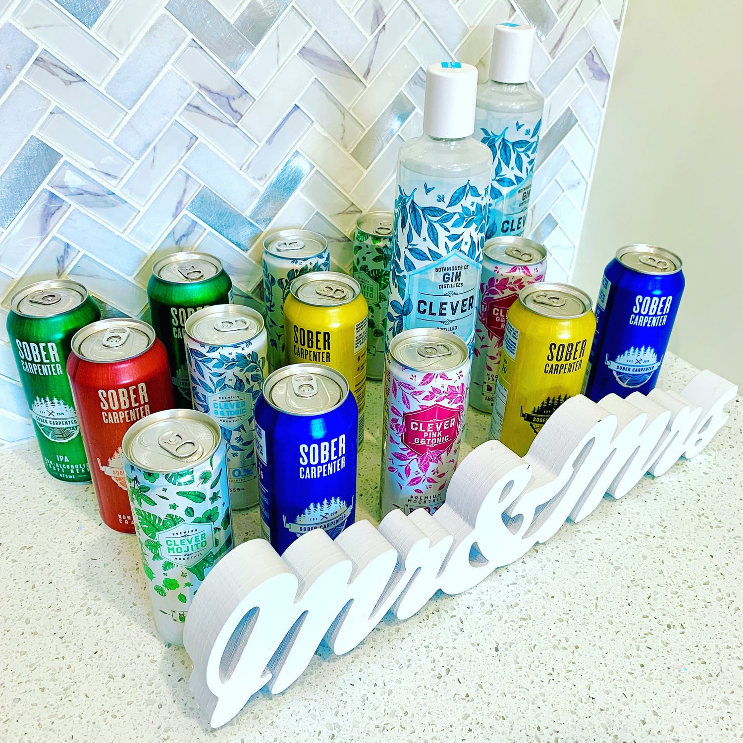 A photo showing a Mr. and Mrs. sign in front of a mix of adult appropriate non-alcoholic drinks.