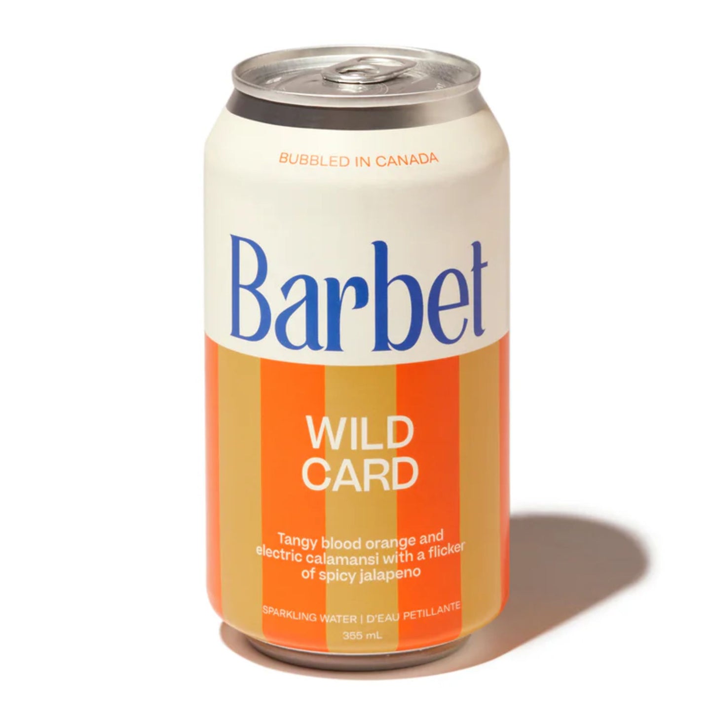 Barbet Wild Card non-alcoholic sparkling water 355mL can on a white background. The can features bold white and gold/orange vertical stripes and the full flavor description: "Tangy blood orange and electric calamansi with a flicker of spicy jalapeño." The product is Bubbled in Canada.
Available at Knyota Drink in Ottawa