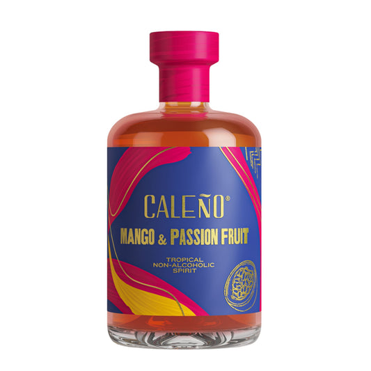 Clear glass bottle of Caleño Mango & Passion Fruit Tropical Non-Alcoholic Spirit with a vibrant orange liquid. The label is deep blue with bold pink, yellow, and gold accents. The text reads "CALEÑO MANGO & PASSION FRUIT TROPICAL NON-ALCOHOLIC SPIRIT." The bottle features a bright pink cap and is set against a white background.