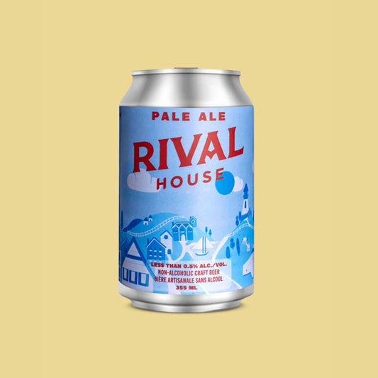 A silver can of Rival House Pale Ale against a pale yellow background. The can's label is light blue and features a whimsical, light-toned village scene with buildings and trees. "RIVAL HOUSE" is printed in large red letters at the top, and "PALE ALE" is written in blue above it. The bottom of the label has text that reads "LESS THAN 0.5% ALC./VOL. NON-ALCOHOLIC CRAFT BEER" and "BIÈRE ARTISANALE SANS ALCOOL" along with "355 mL".