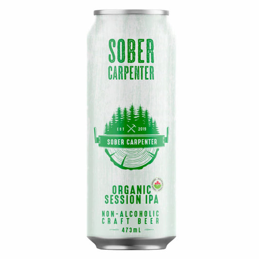 A full-shot image of a 473ml can of Sober Carpenter Organic Session IPA. The can has a white, textured design resembling distressed wood grain, featuring a prominent logo with a green cluster of pine trees, a cross-hatched axe, and a circular wood-cut graphic. Bold green text clearly labels the product as "Sober Carpenter," "Organic Session IPA," and "Non-Alcoholic Craft Beer," highlighting its use of Galaxy hops for tropical and citrus notes. Proudly crafted in Quebec.
Available at Knyota Drink in Ottawa.
