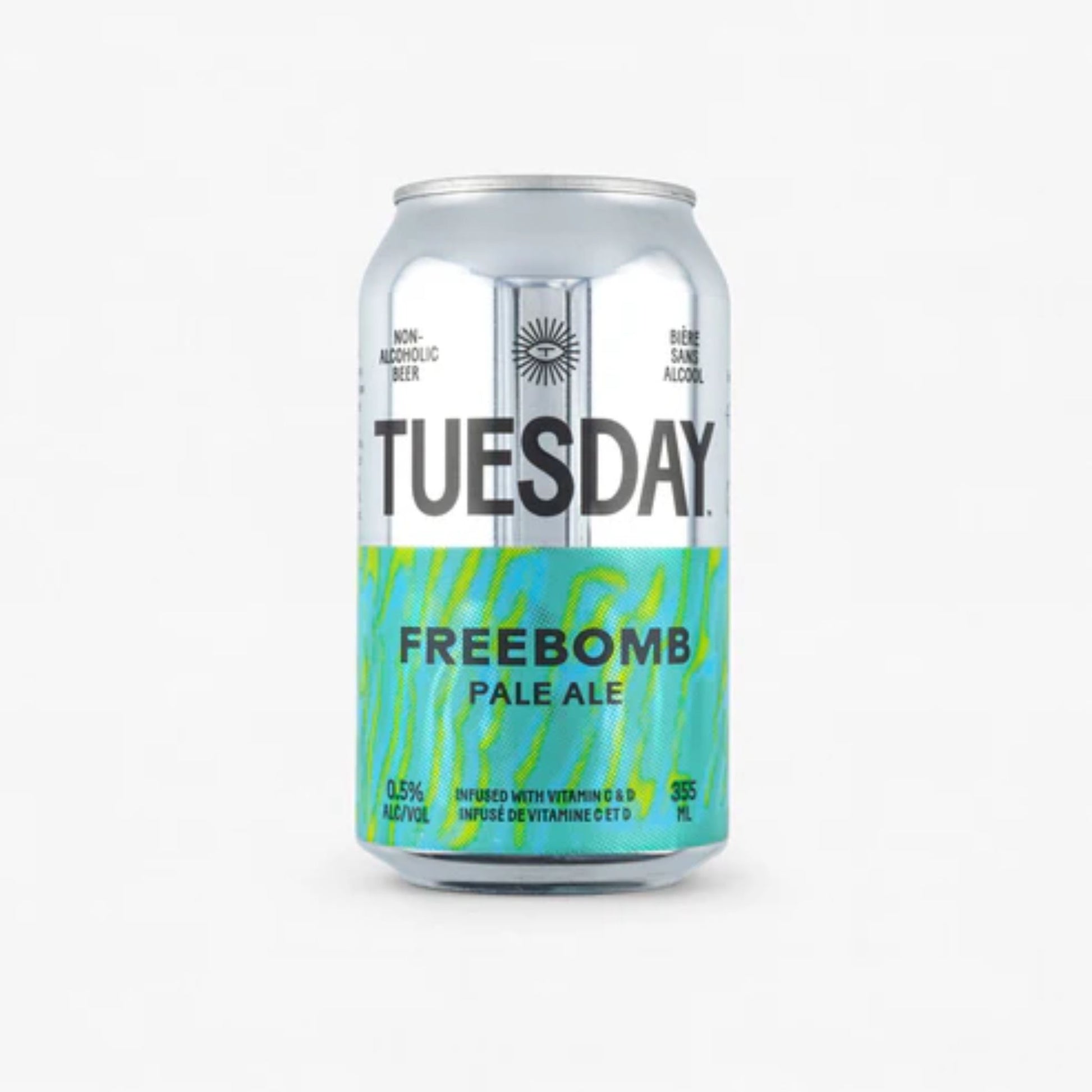 The image shows a silver can of Tuesday Freebomb Non-Alcoholic Pale Ale. The can has a black label with the brand name "Tuesday" in large white letters. The can is labeled as non-alcoholic beer with 0.5% alcohol by volume. It is also infused with vitamins C and D.