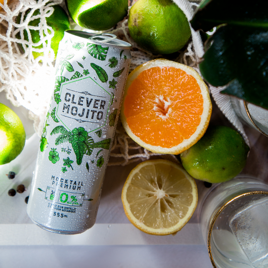 A can of Clever Mojito Mocktail against a backdrop of citrus fruits. Available for sale at knyota.com.