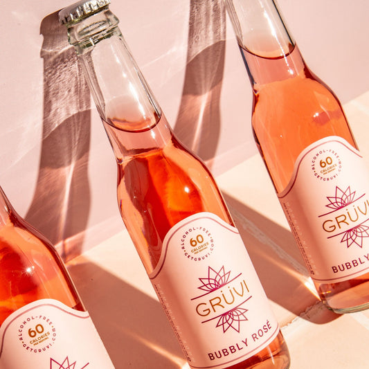 A photo of three Grüvi Bubbly Rosé. Gruvi is available for sale at knyota.com