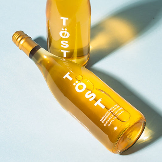 A photo of a full sized bottle of Töst Sparkling White Tea, Cranberry, and Ginger. Töst can be purchased from Knyota Drinks